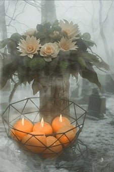 A serene, misty forest scene with glowing candles and soft flowers arranged in remembrance. The fog enhances the atmosphere of peace, reflection, and tribute, evoking feelings of memory, spirituality, and the beauty of silence in nature’s stillness.