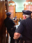 city council meeting, police officers watching, police officers