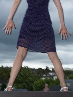 girl standing over a cliff