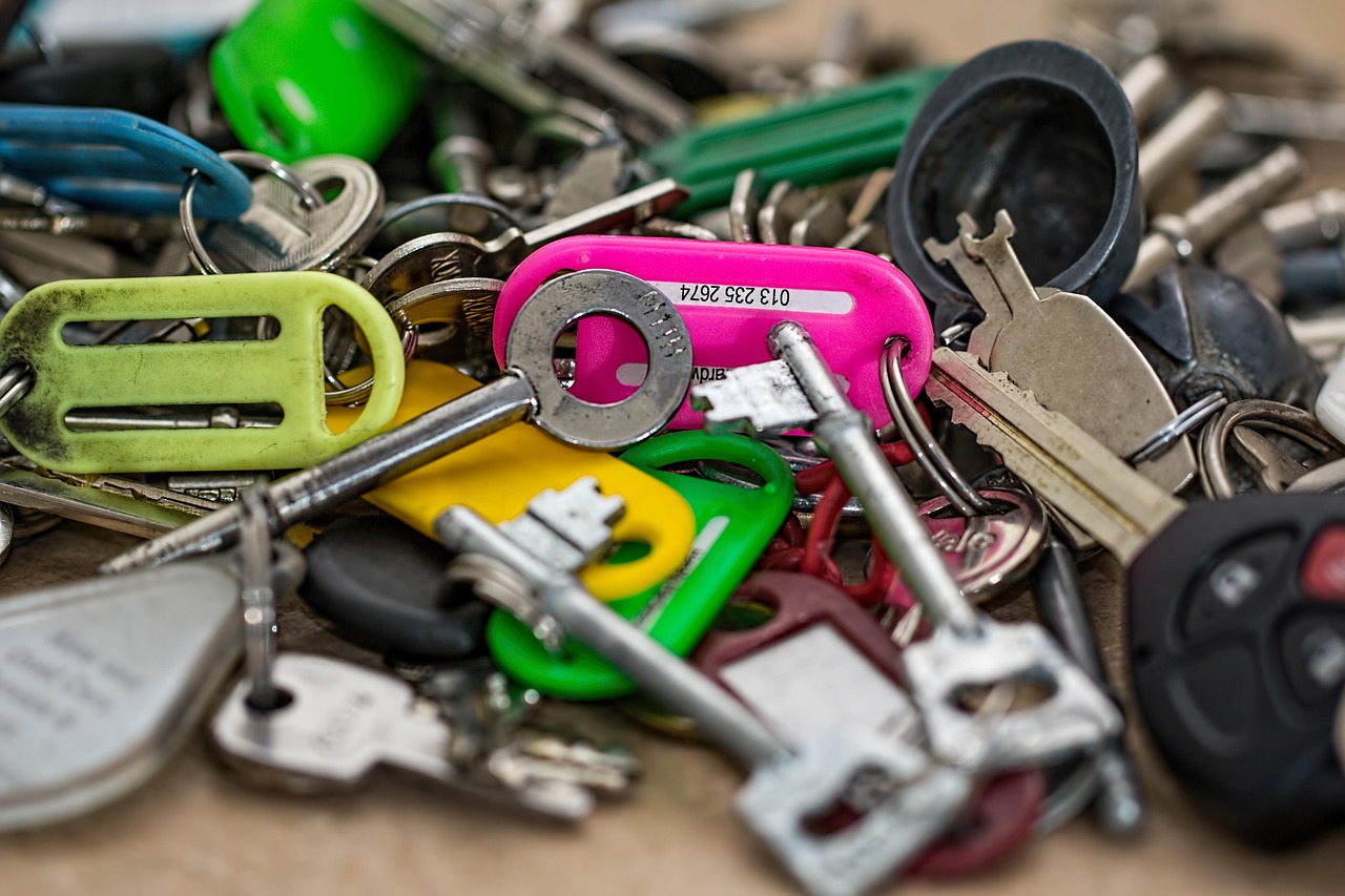 Several metal keys on a key ring lying on a flat surface.