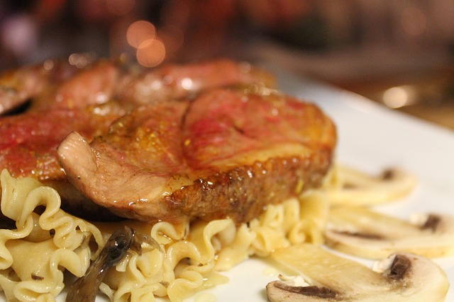 Raw duck breast with the skin scored in a diagonal diamond pattern before searing