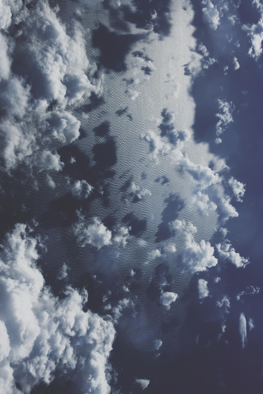 View from an airplane window over clouds and ocean on the way to Montego Bay, Jamaica