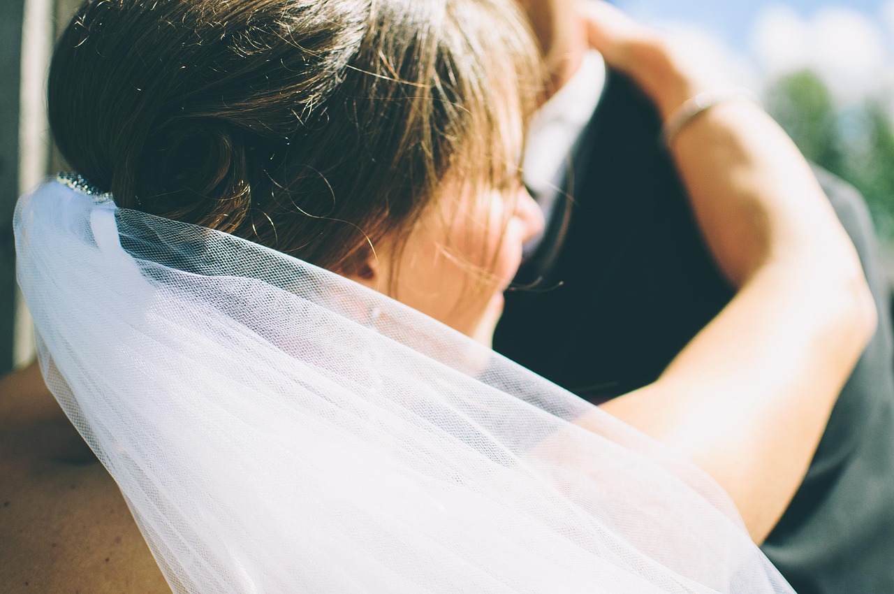 Sophie and Daniel embracing in sunlit close-up