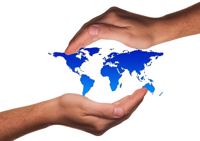 Free hands keep map of the world illustration