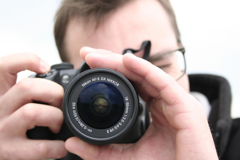 camera taking photo photographer free photo on pixabay