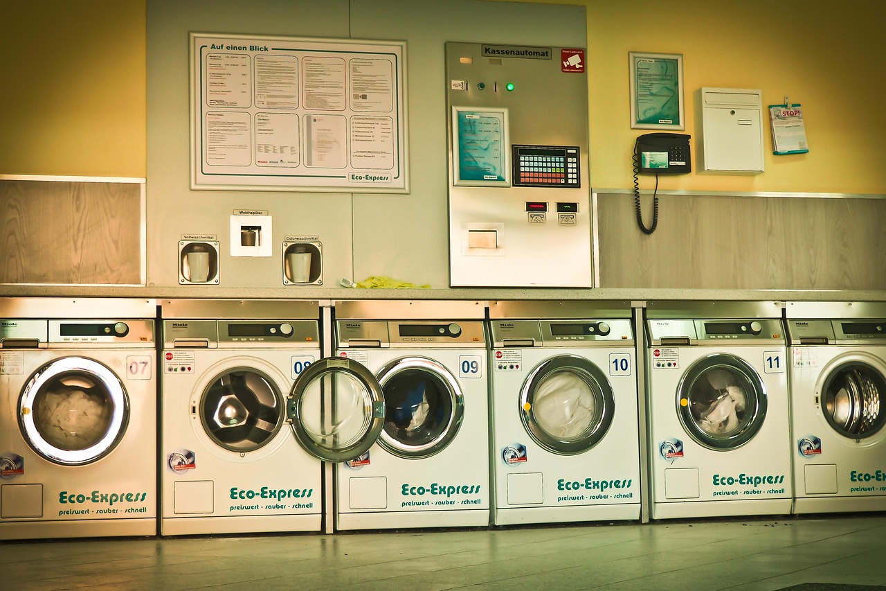 A row of front-loading commercial laundry machines
