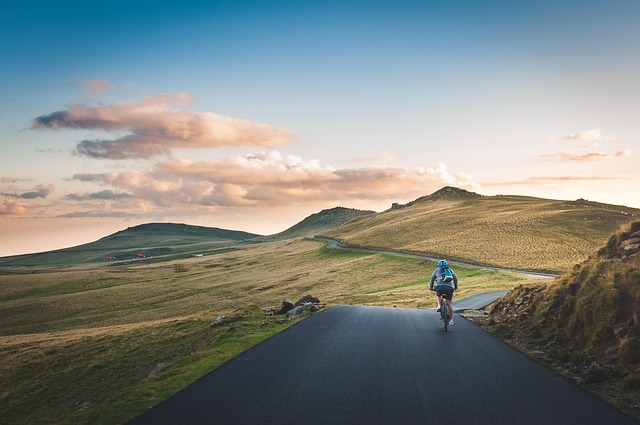 cropland, cyclist, grass, grassland, nature, hills, landscape, mountain, outdoors, road, scenic
