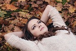 beautiful girl, in the park, lying on the leaves