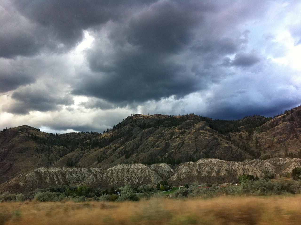 Storm clouds over dry hills near Kamloops BC