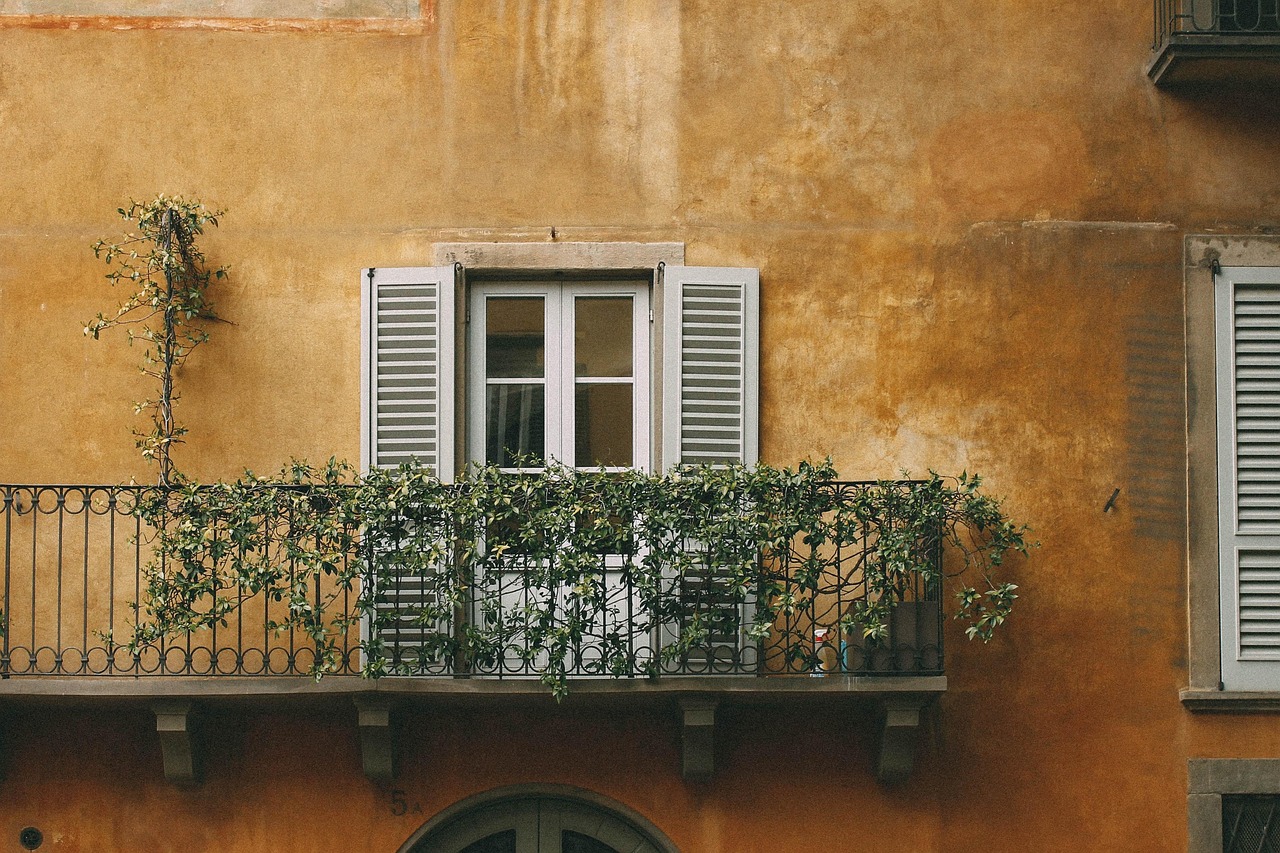 small balcony ideas UK with cosy cushions and outdoor textiles