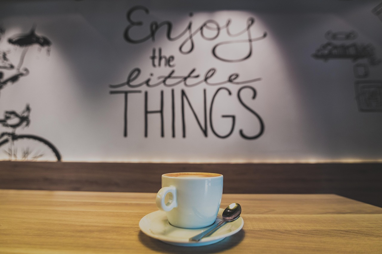 a cup of coffee in a coffee shop with sayings