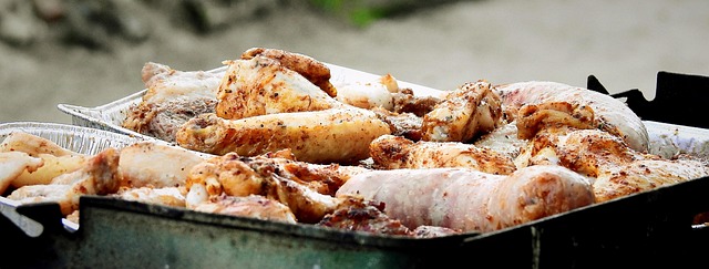 Chicken thighs on a hot grill with visible sear marks and rendered fat