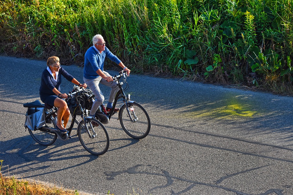 Elderly couple cycling in the country