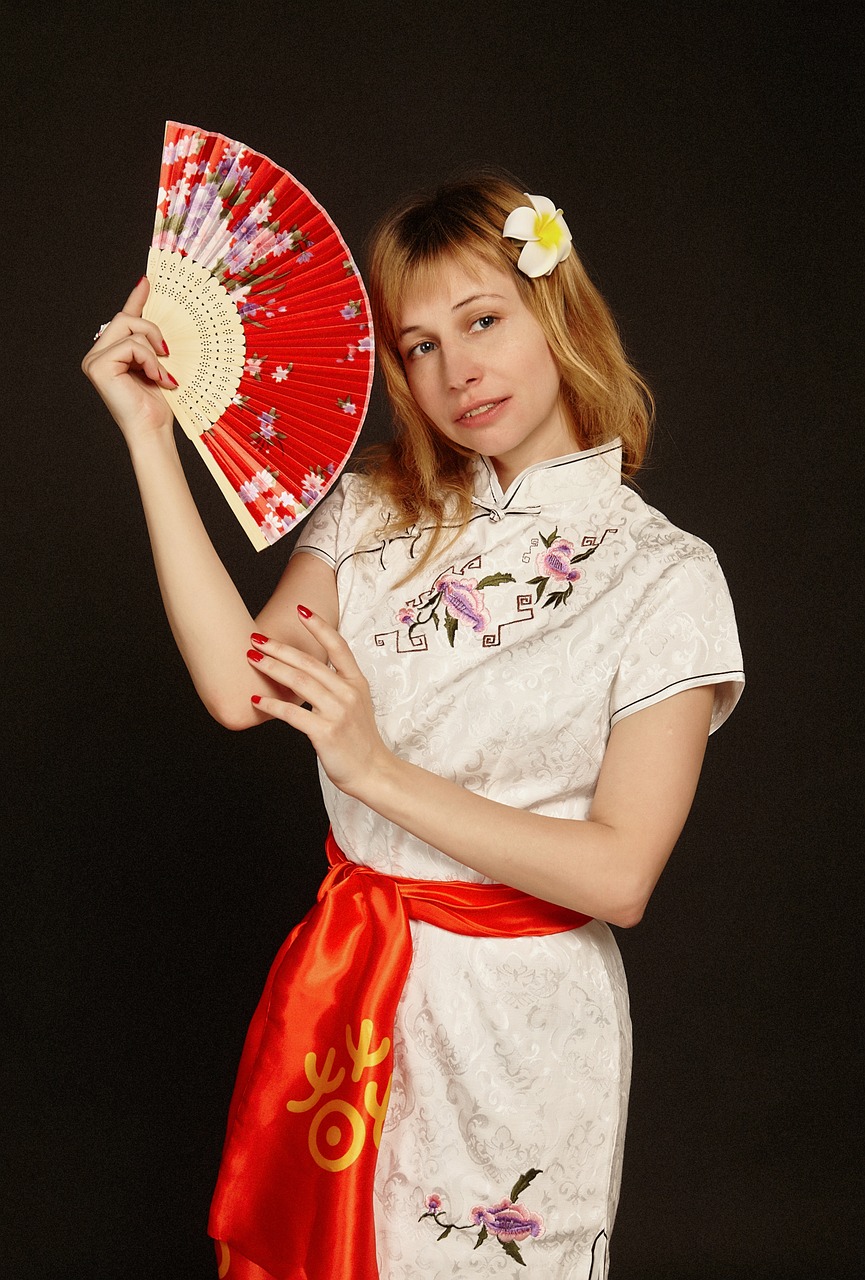 Chinese woman in elegant embroidered dress showing the cultural depth and grace that inspires the cheongsam bag collection