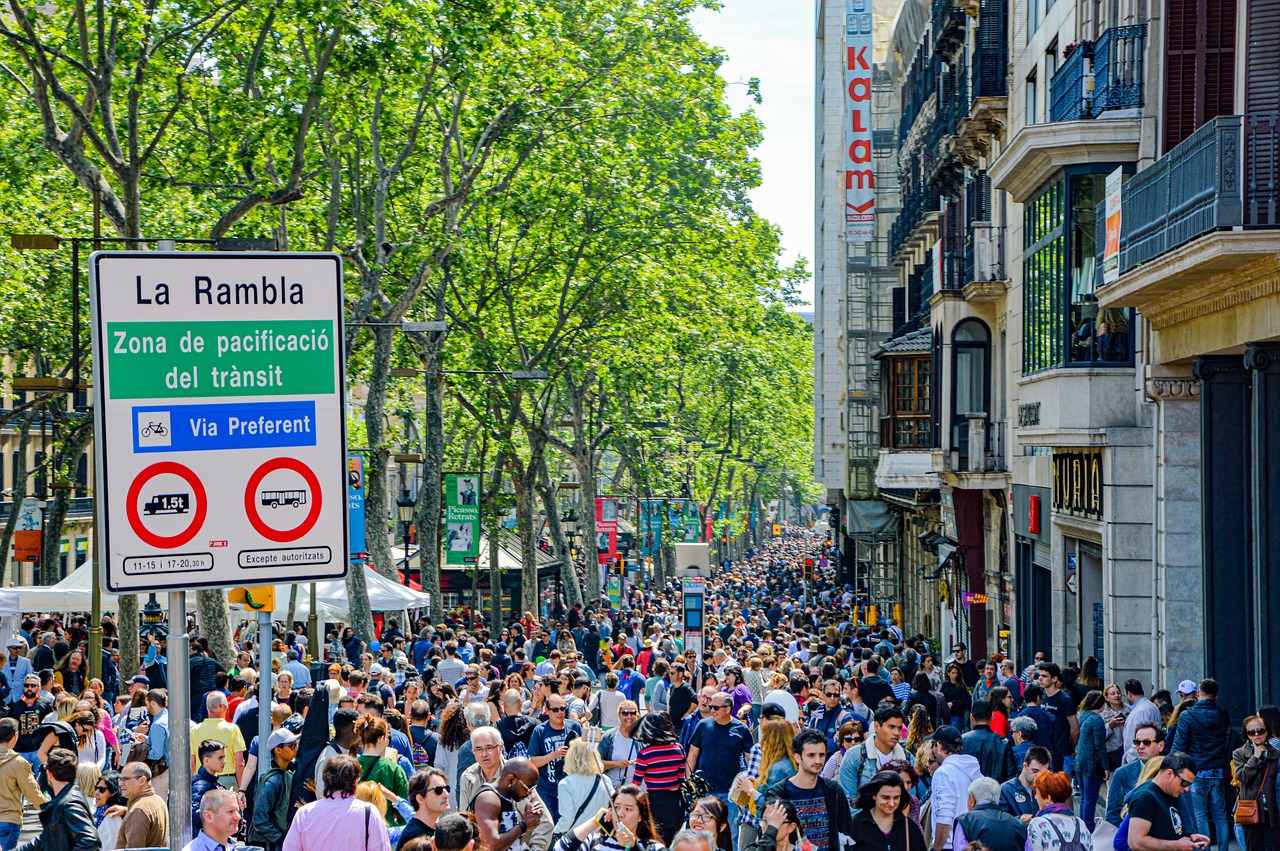 Barcelona's Las Ramblas with pedestrians and historic architecture in the late afternoon