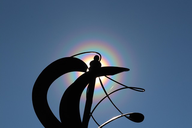 yard art, sun dog, rainbow, nature, backyard, halo, iridescent, blue sky, sun, metal wind mill, clear sky, blue rainbow, blue art, blue metal