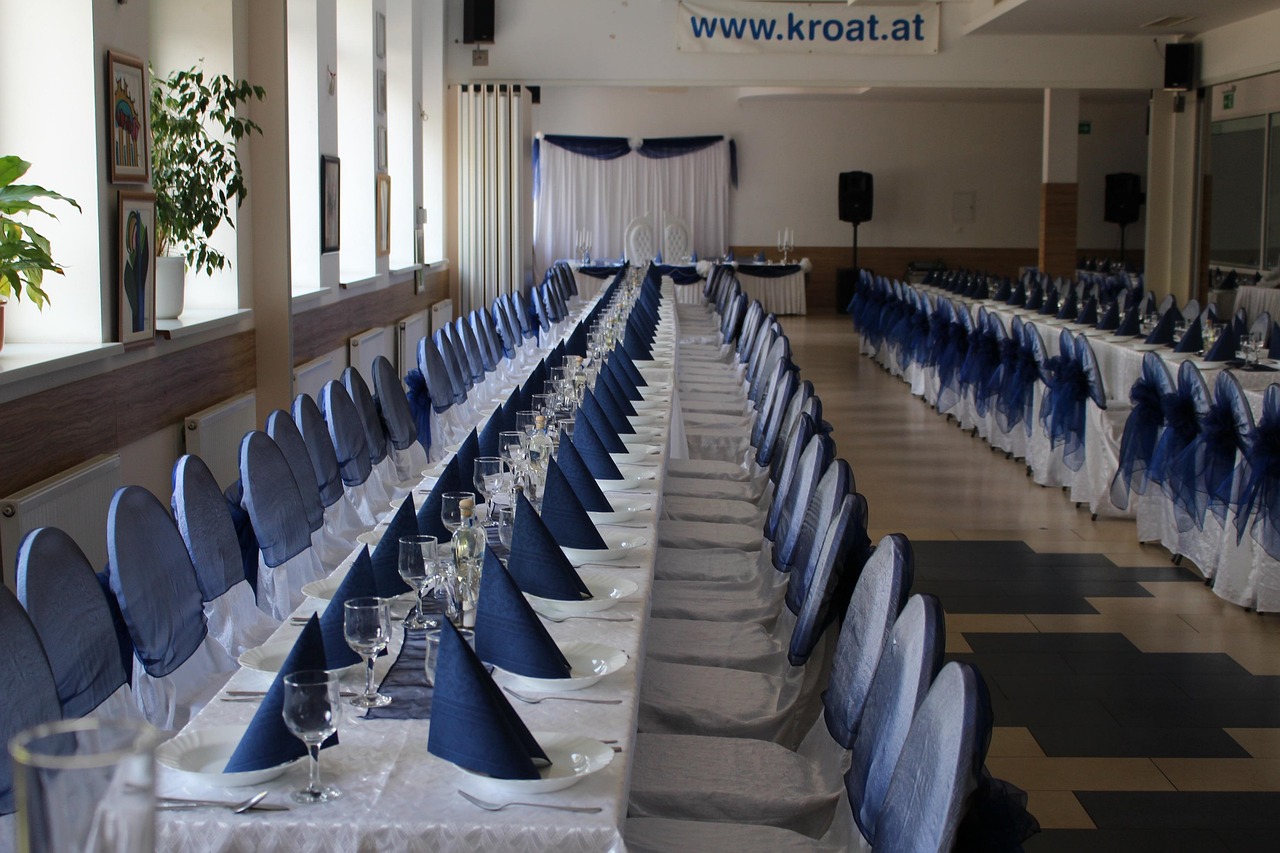 Large hotel event hall set up with chairs and staging for a conference