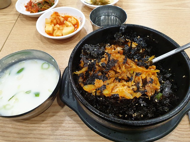 Korean bibimbap bowl with rice, vegetables, meat, egg and gochujang arranged in wedges