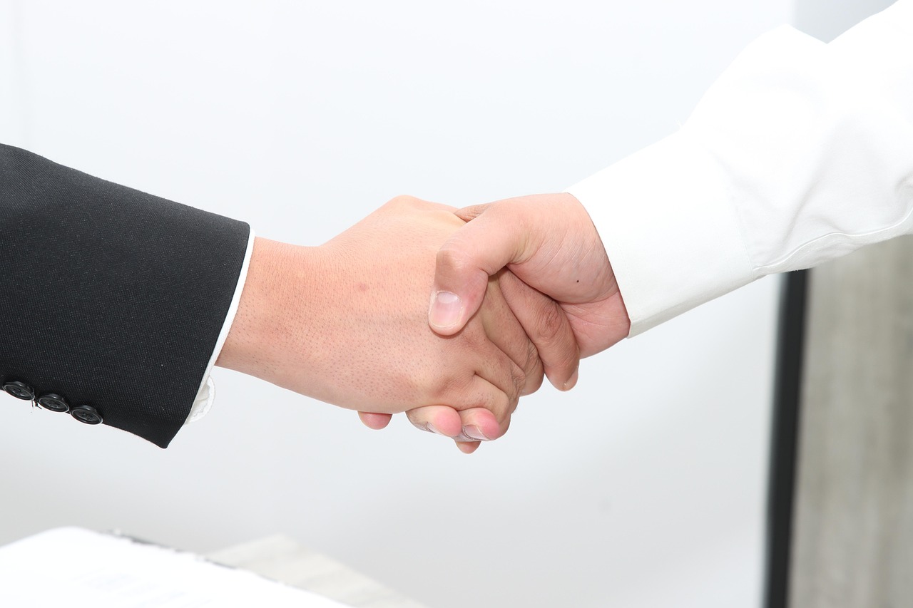 Two people shaking hands over an agreement