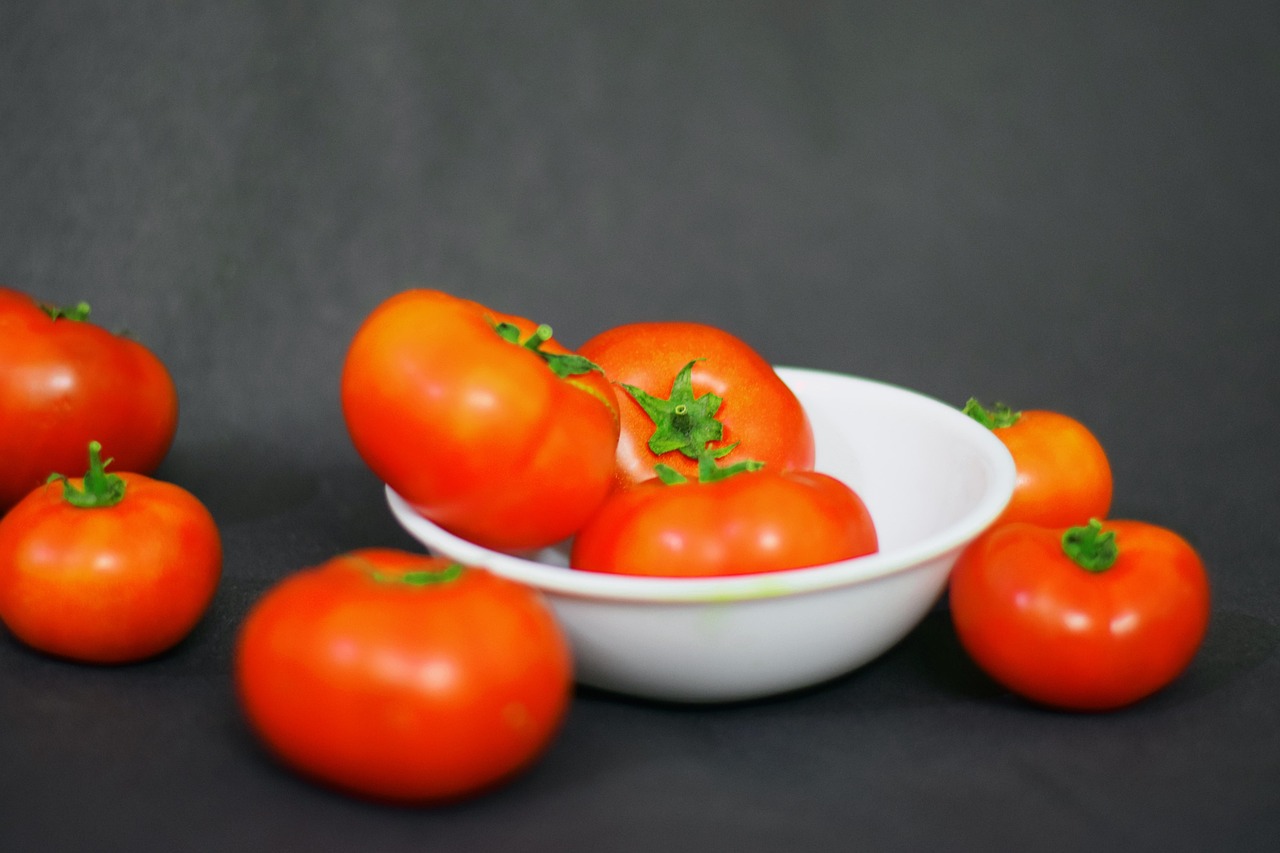 Fresh fruit tomatoes and red tomatoes on a wooden board