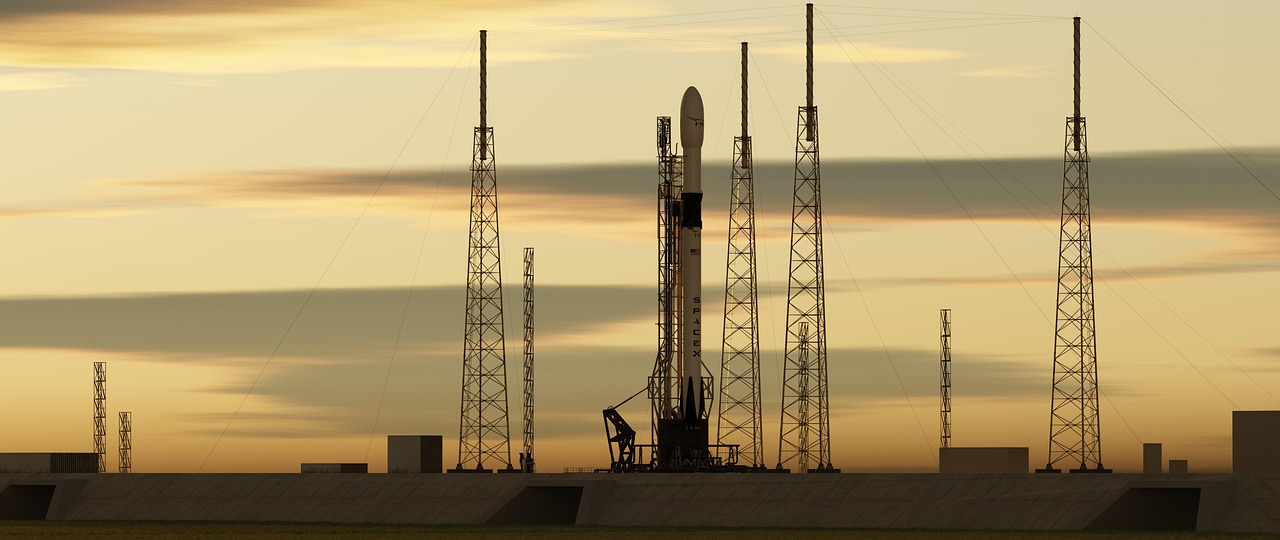 Rocket launching upward against a dark sky with bright engine flames below.