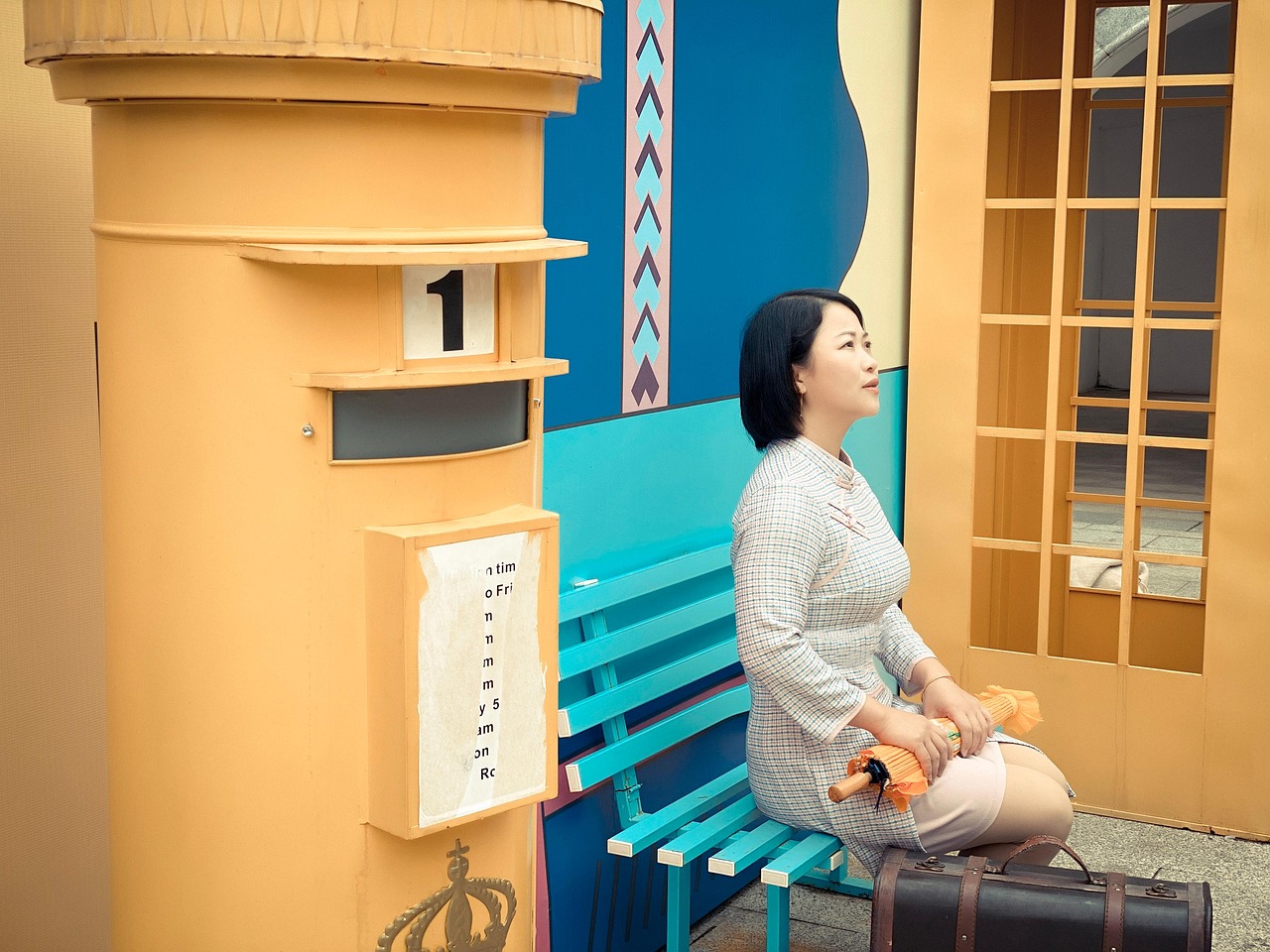 A fashionable young woman wearing a Chinese-influenced outfit with an embroidered decorative bag, showcasing the fusion of heritage aesthetics and modern styling.