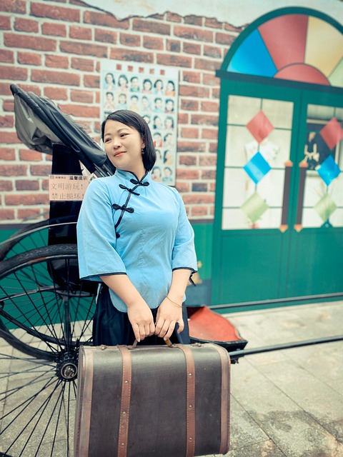 A woman dressed in Chinese-inspired fashion carrying a decorated cultural bag in an outdoor setting, representing the versatility of embroidered bags across settings.