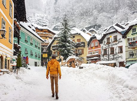 Free A Man Walks On A Snowy City Street photo and picture