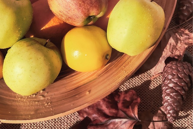 autumn fruits, apples, rustic food, fall composition, healthy eating, seasonal fruit, nature closeup, harvest time, fruit still life, golden apples, cozy autumn, fruit bowl, autumn colors, thanksgiving decor, pinecones, fall leaves, orchard fruit, natural texture, rustic kitchen, yellow apples, autumn vibes, healthy lifestyle, farmhouse aesthetic, country table, fresh harvest