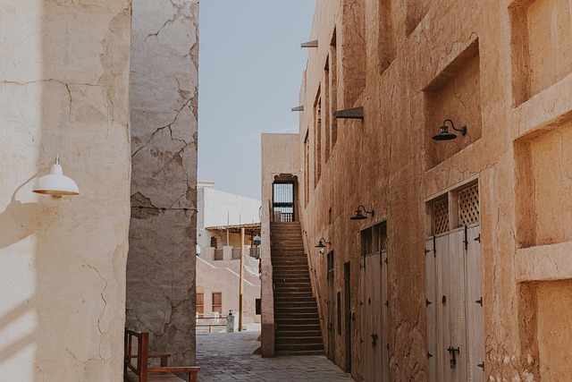 al seef, dubai, narrow alley, stone buildings, stairs, traditional architecture, middle eastern design, historic area, cultural heritage, arabic architecture, rustic walls, outdoor stairs, ancient architecture, old town, heritage site, historic preservation, tourism, travel destination, alleyway, old dubai, urban landscape, traditional structures, vintage charm
