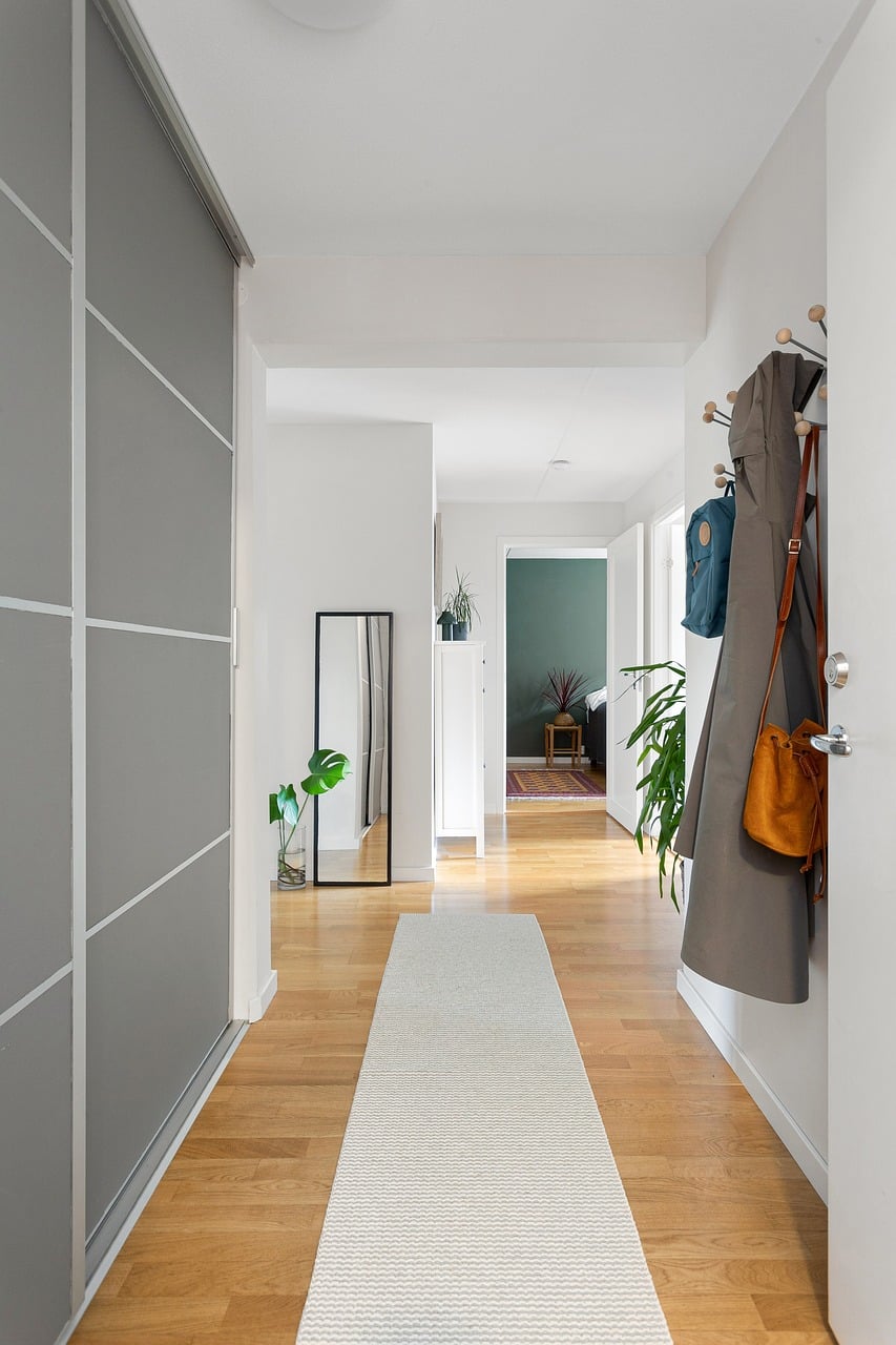 Round mirror in a small foyer creating a brighter and larger entryway