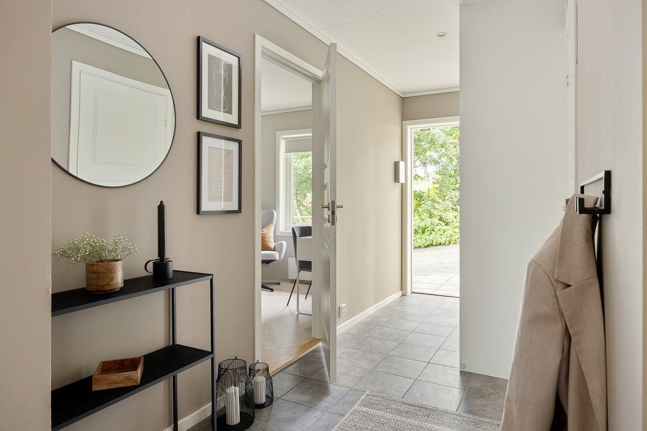Slim entryway furniture in a narrow hallway with compact bench and wall shelf