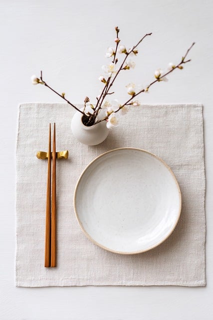 japanese table setting, plum blossom, ume, chopsticks, ceramic plate, linen placemat, minimal, white background, top view, flat lay, new year, spring, wabi sabi, japandi, nature, neutral colors, home decor, tableware, zen, clean, soft light