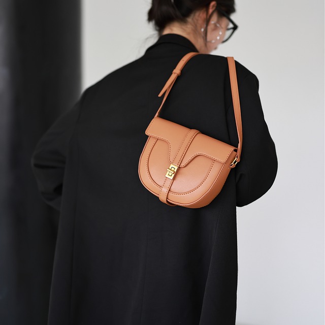brown handbag, modern style, woman with glasses, fashion accessories, black coat, woman from behind, shopping bag, personal style, women's fashion, luxury accessory, minimalist look, elegant look, leather handbag, female elegance, luxury fashion, classic design, handbag, contact lenses, everyday fashion, leather material
