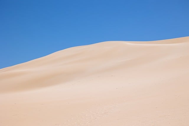 Namibia, sand dunes, desert and blue sky — photo by jhamel0210