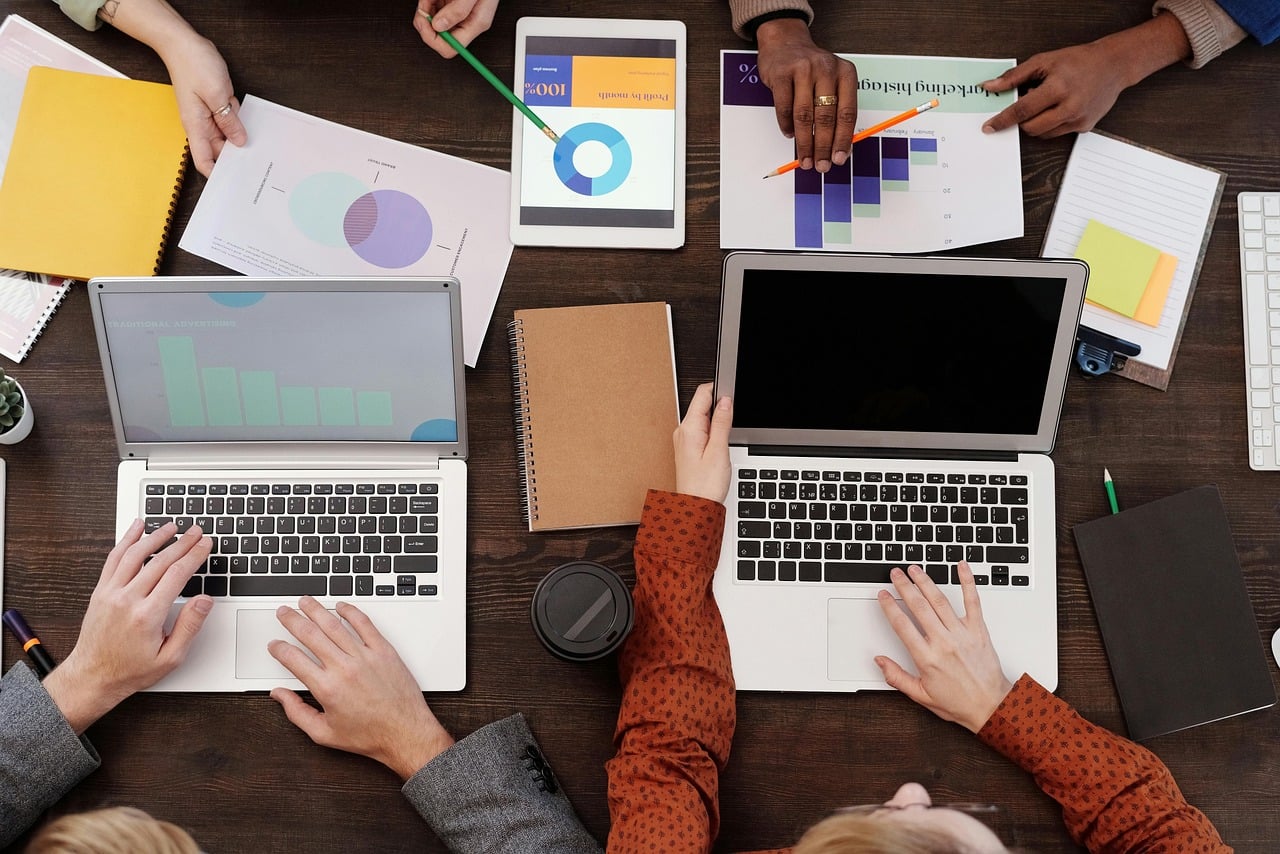 work meeting, notebook, charts, report, work desk, office, collaboration, ideas, discussion, planning, writing, teamwork, smart device, office tools, contemporary, business analysis, data, office paper, table