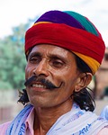 Random: traditional clothing, man, smiling, mustache, red turban, cultural customs, colorful, outdoors, cultural attire, experience, blue shirt, ethnic affiliation, travel, men's fashion, traditional culture, person, culture, age, lively, indian