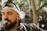 Random: portrait, model, man, style, fashion, smoke, smoking, vaping, cigarette, tobacco, man with sunglasses, leather jacket, cap, beard, youth, hat, earring, man with cap, earring in ear