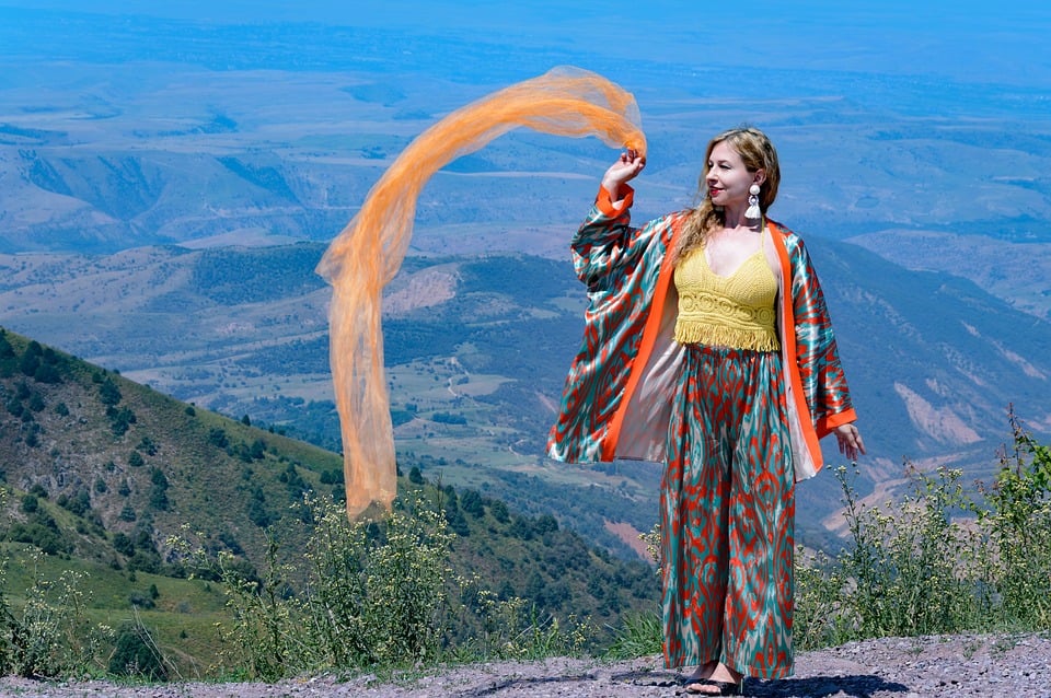 Woman with flowing scarf at mountain viewpoint photo - Pixabay