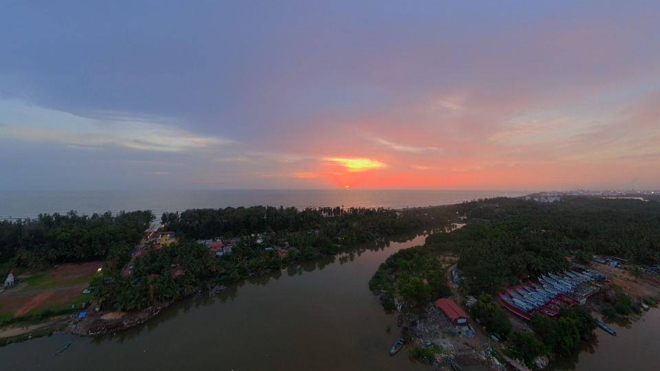 aerial view, river estuary, coastline, sunset, tropical landscape, vibrant sky, golden hour, winding river, drone footage, nature, landscape, sea, dusk, evening, serene, tropical, water, greenery, beautiful, coast, calm, natural beauty, aerial shot, 4k footage, daylight